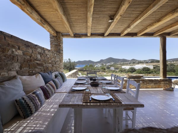 The shady al fresco dining area is served by a large barbecue.